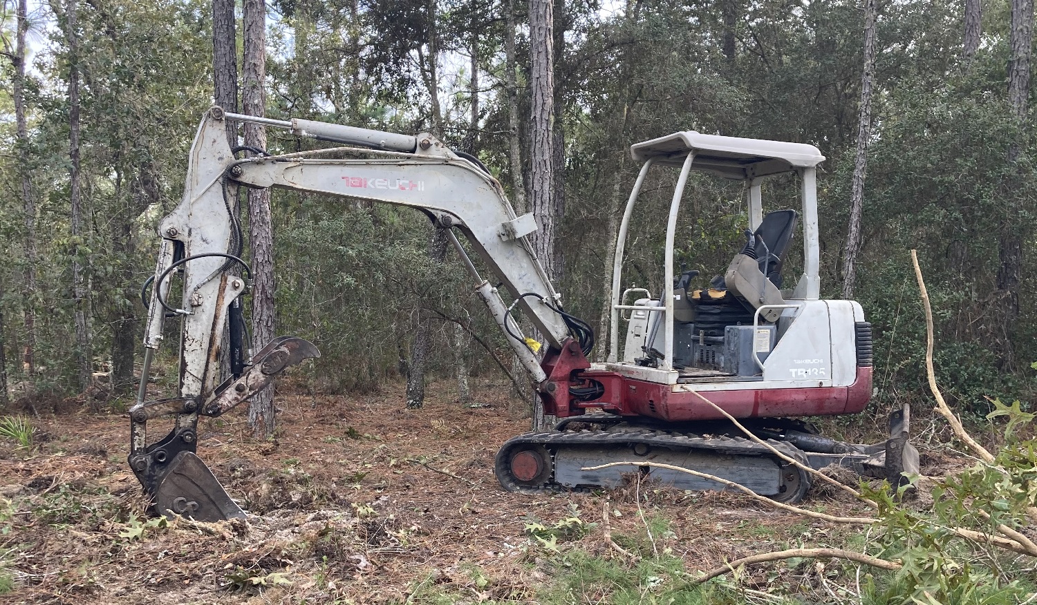 Excavator moving earth on a cleared South Florida site