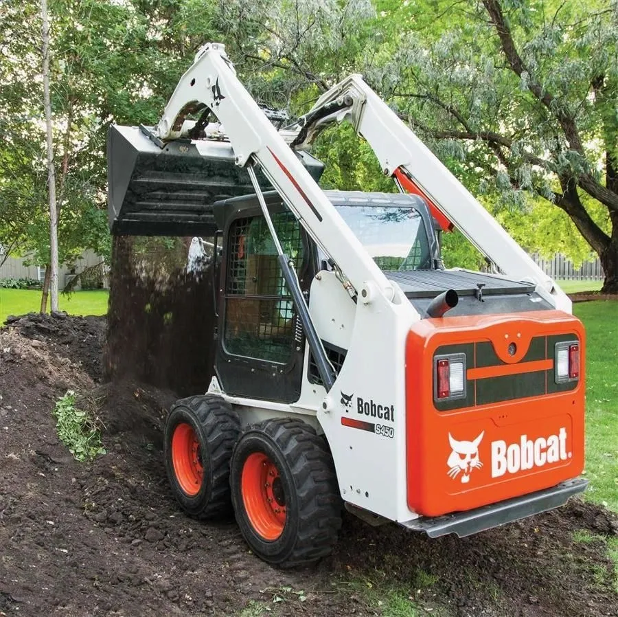 Bobcat skid steer loader working on a cleared lot