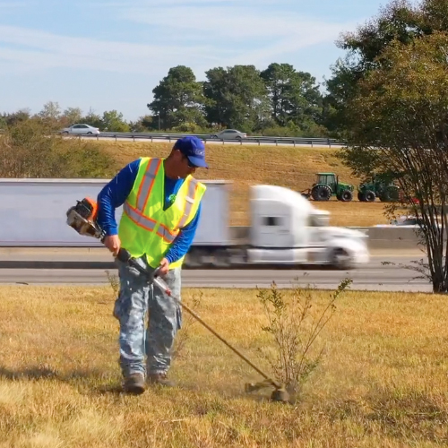 Crew member edging along a commercial property roadside